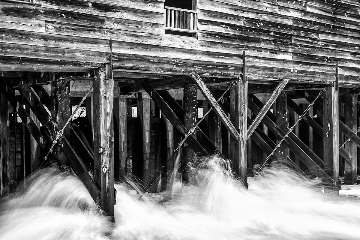 A bridge mill with water rushing through the bottom at George L Smith State Park in Twin City, GA.